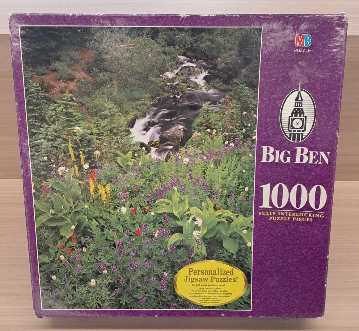 puzzle cover of Mt. Rainer National Park with a lot of foliage and a waterfall.