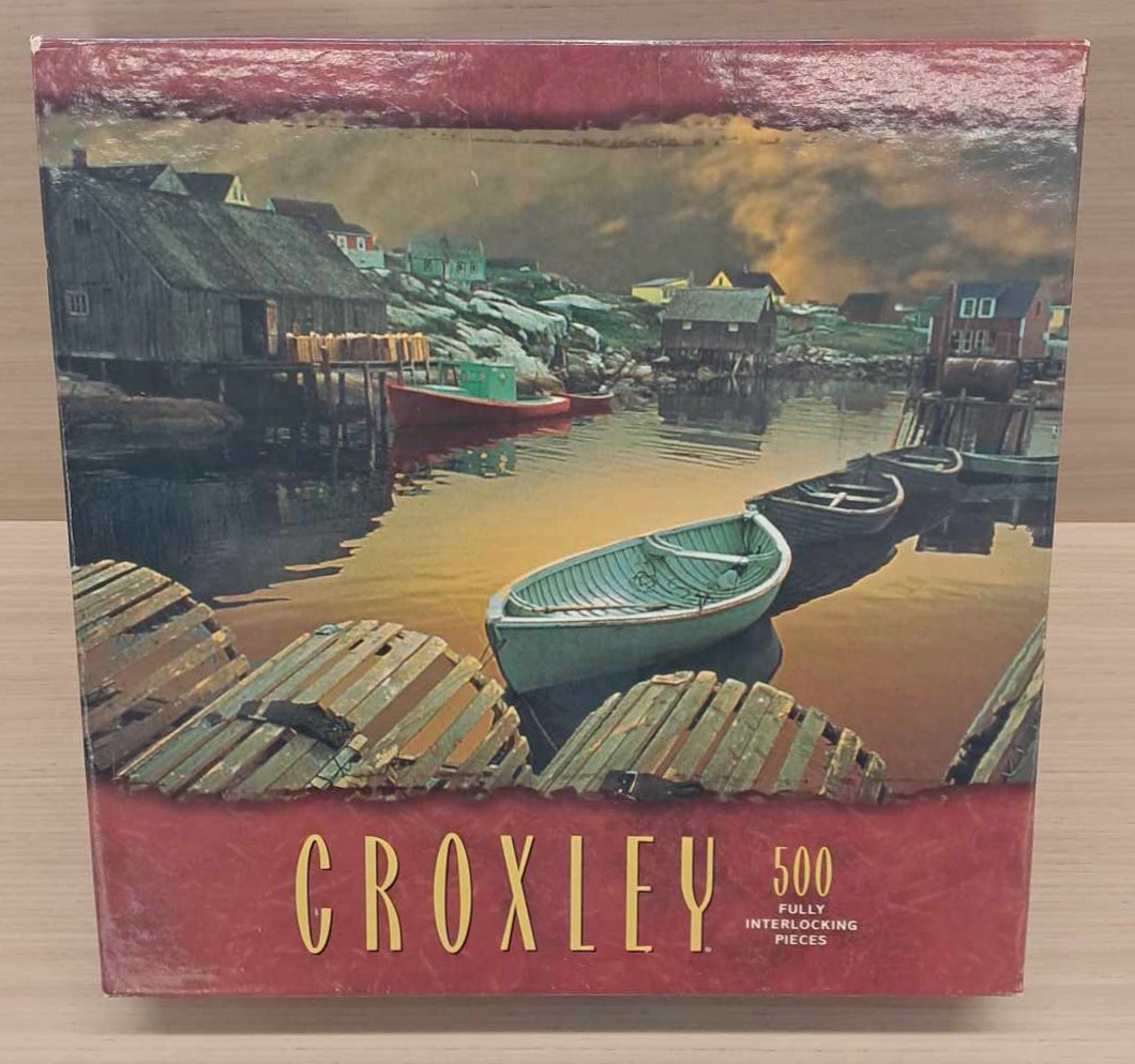 Puzzle Cover showing boats drifting on the water with houses along the shore.