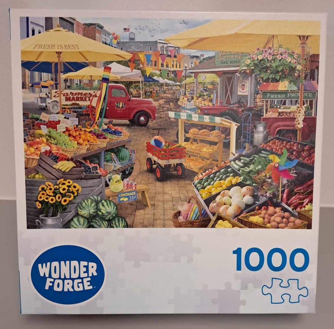 Image of a Puzzle cover with a cartoon rendering of a farmers market with stalls of fresh produce under yellow umbrellas.