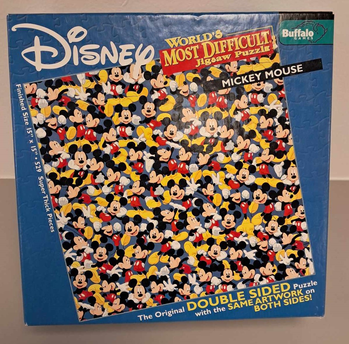 Image of a puzzle cover with many cartoon Mickey's scattered all over to increase the level of difficulty.