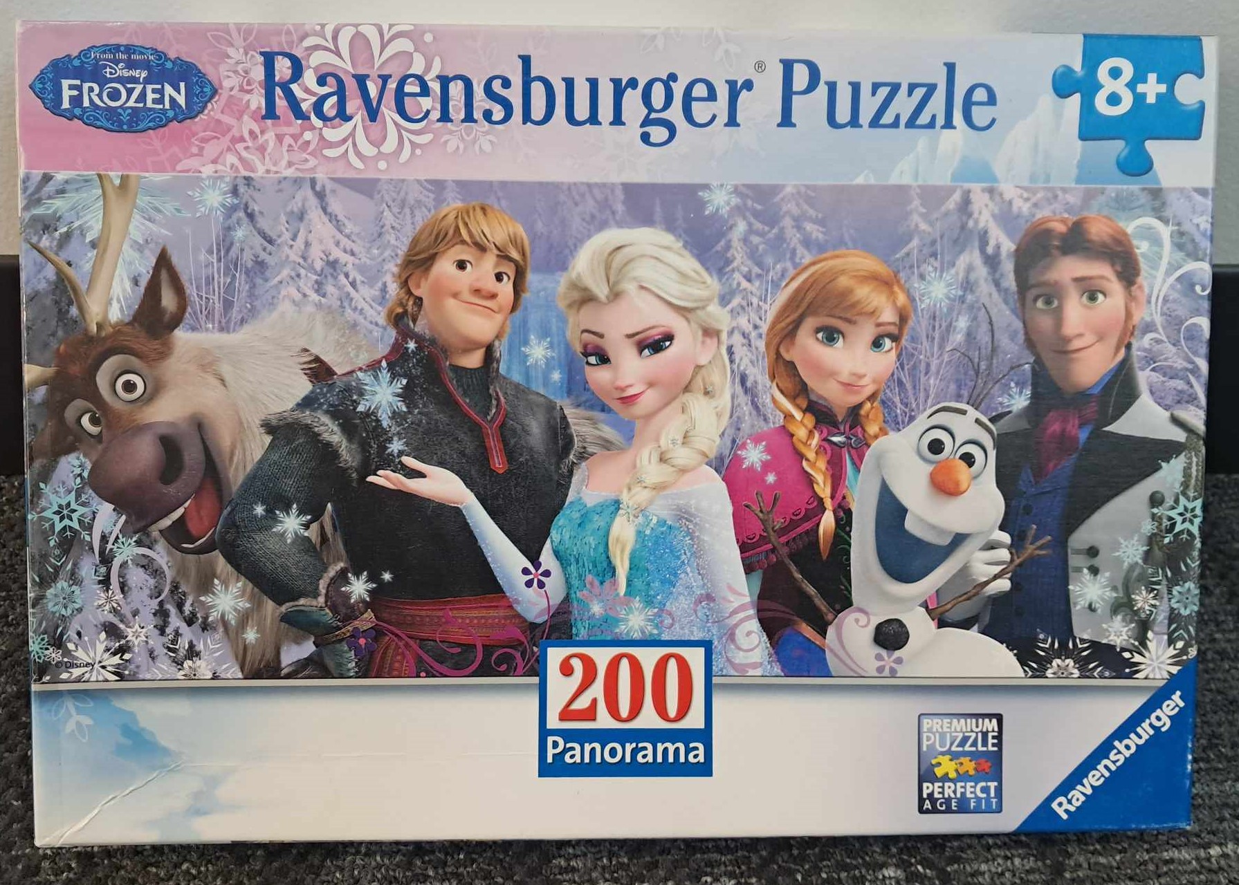 Image of a puzzle cover showing a picture of the cast from the movie Frozen.