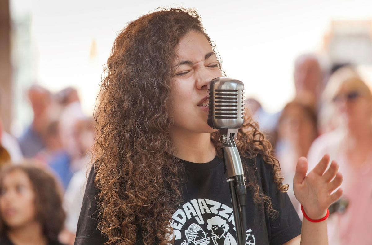 A woman singing into a microphone.