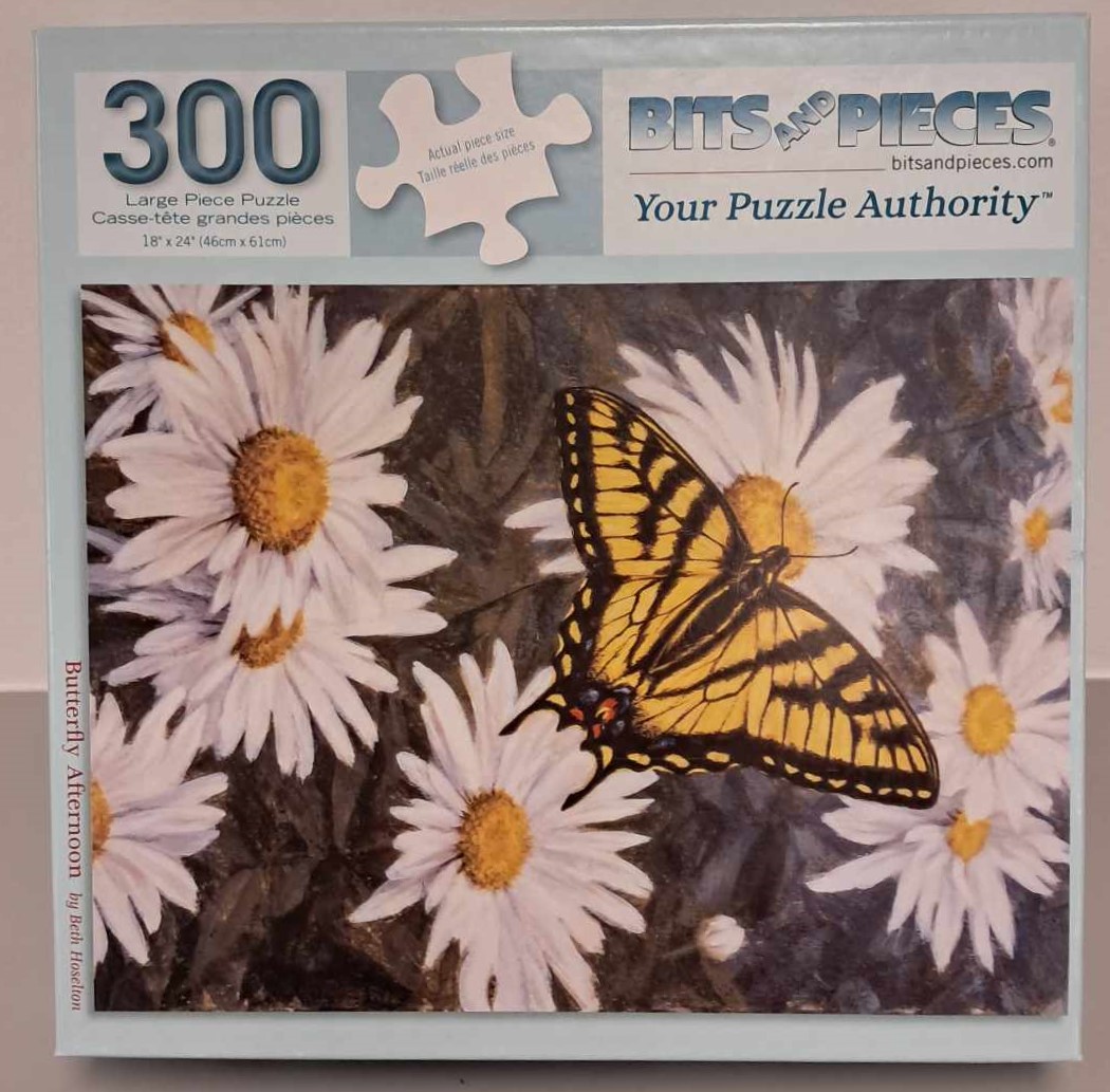 Puzzle Cover of a photograph of a yellow butterfly sitting on a white daisy.