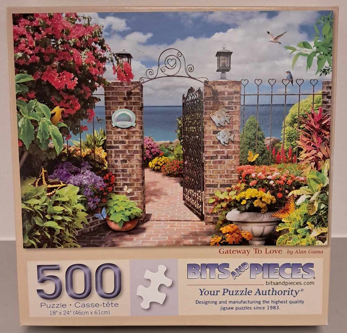 Puzzle cover showing an image of a brick gateway through a garden near a lake.