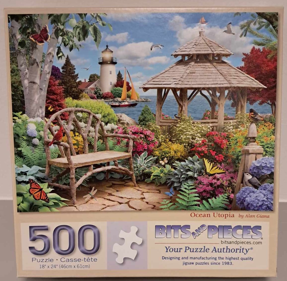 Puzzle cover showing an image of a bench and gazebo near an ocean and light house with a lush garden.