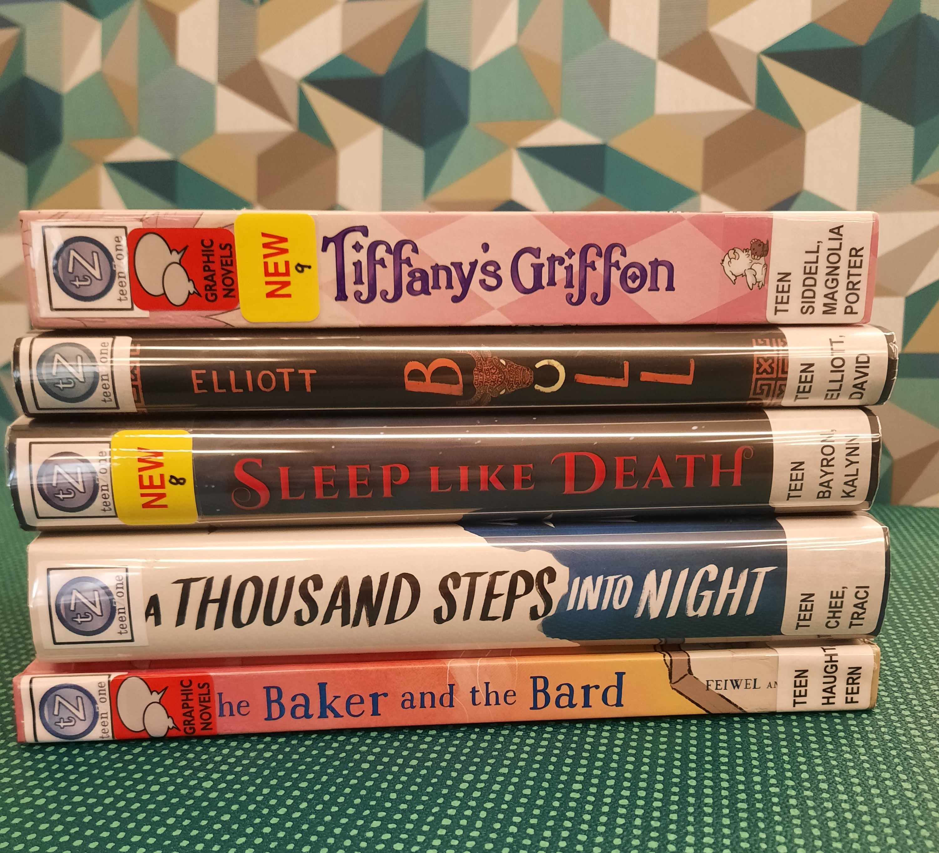 Book Stack showing the following titles: "Tiffany's Griffon," "Bull," "Sleep Like Death," "A Thousand Steps into Night," and "The Baker and the Bard"