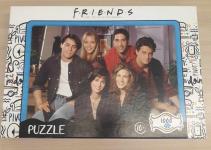 Image of a puzzle cover titled "Friends" showing the cast of the sitcom show "Friends."