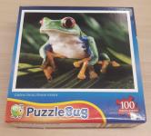 Image of a puzzle cover titled "Green Frog" that shows a green frog with orange fingers and big red eyes sitting on a plant.