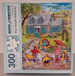 Puzzle cover of an artistic drawing of children with umbrellas splashing in a puddle. A rainbow is in the background.