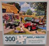 Puzzle cover of an artistic drawing of an Inn sitting next to a river with a boat and two old style cars.